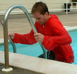 Pull ups on pool ladder with anorak