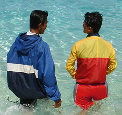 swimming lesson by lifeguard in red and yellow swimwear