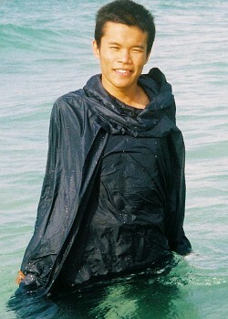 wet blue poncho on beach in water